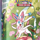 Pokemon TCG: Scarlet & Violet —Prismatic Evolutions Mini Tin - Sylveon (2 Booster Packs & 1 Coin)